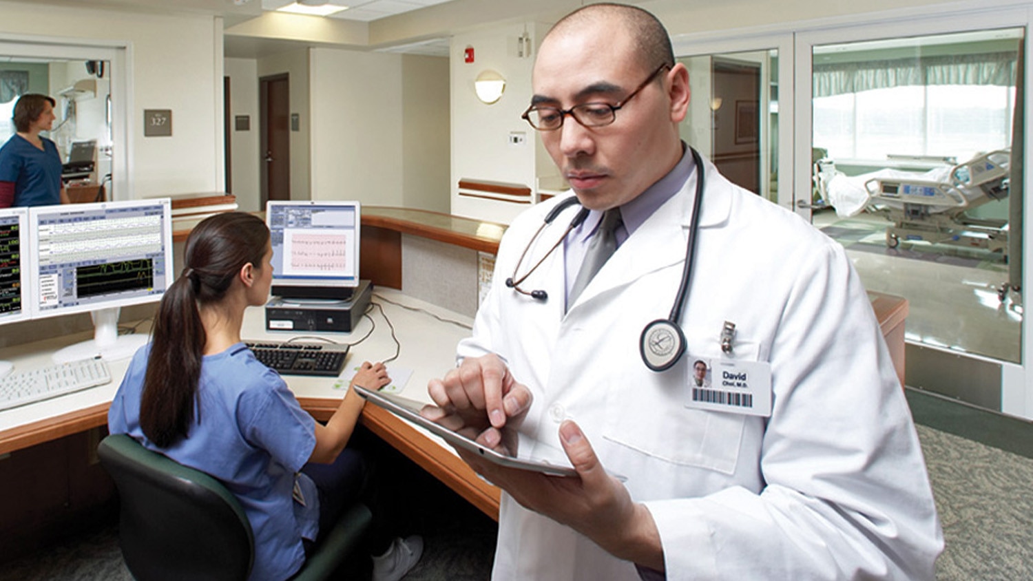 Male doctor consulting a tablet